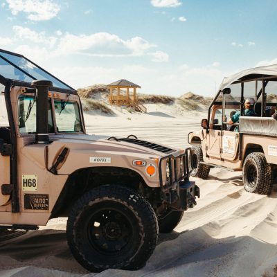 a truck driving down a dirt road