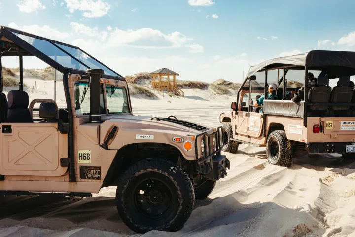 a truck driving down a dirt road