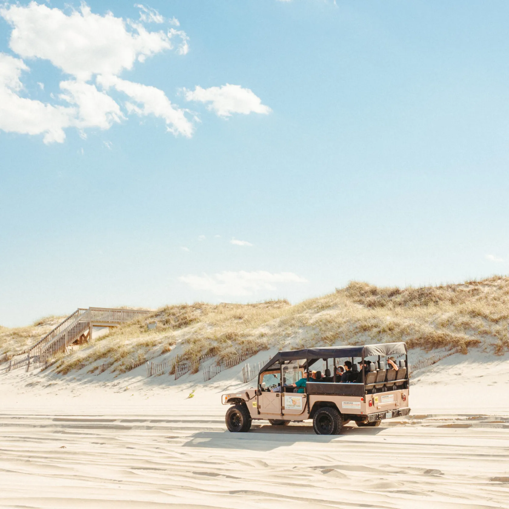 a truck driving down a dirt road