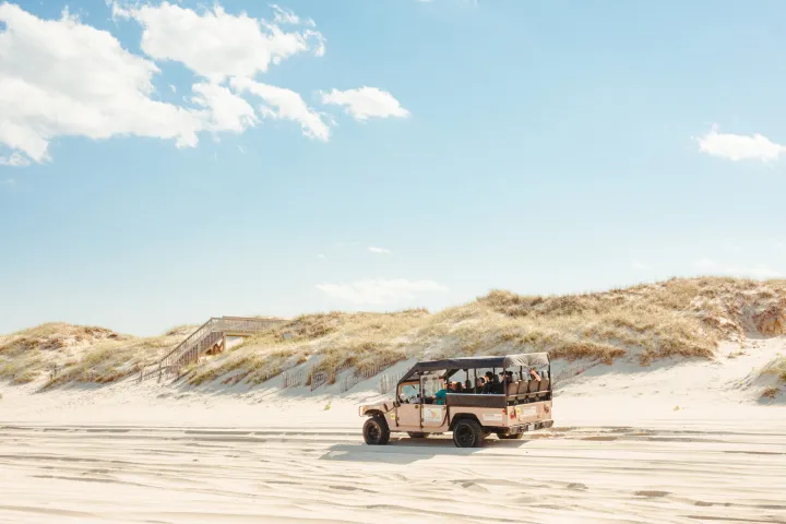 a truck driving down a dirt road