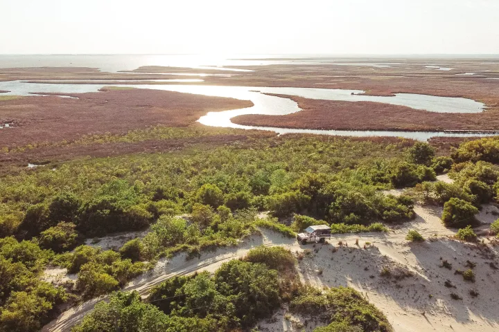 a sign on a rocky beach