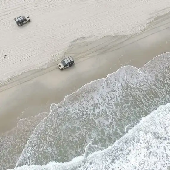 a person riding a wave on top of a snow covered slope