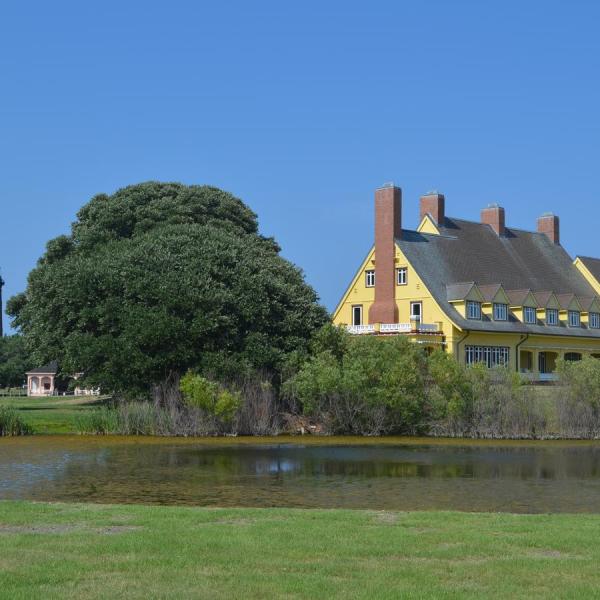 a small clock tower in the middle of a field