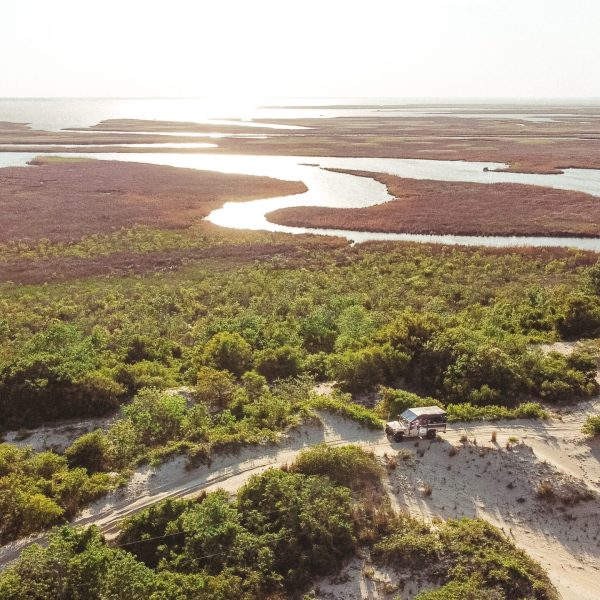 a sign on a rocky beach