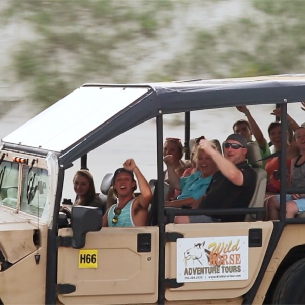 a group of people riding on the back of a truck