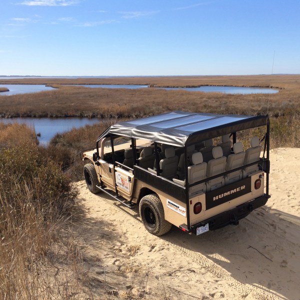 a truck driving down a dirt road